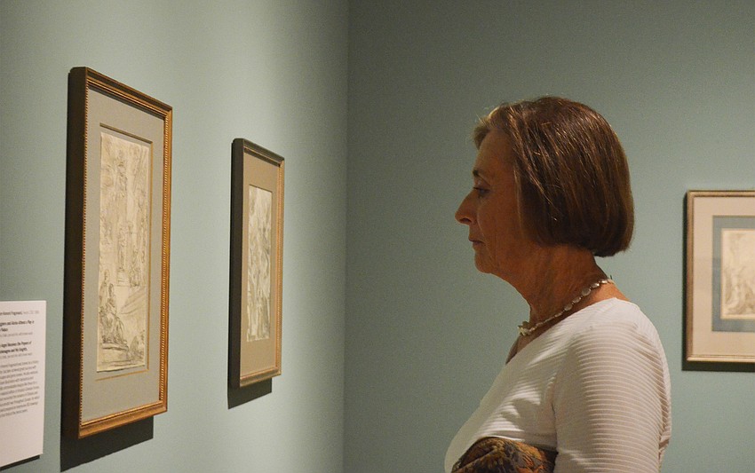 Carolyn Daniel checks out a painting.