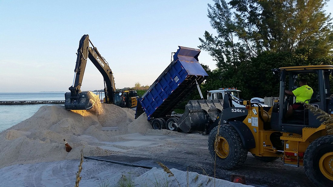 Work crews begin spreading the first loads of sand on a renourishment project on the north end of Longboat Key. (Courtesy photo)