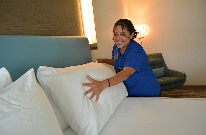 Even Hotels housekeeper  Vicki Jimenez prepares a room for the next guest.