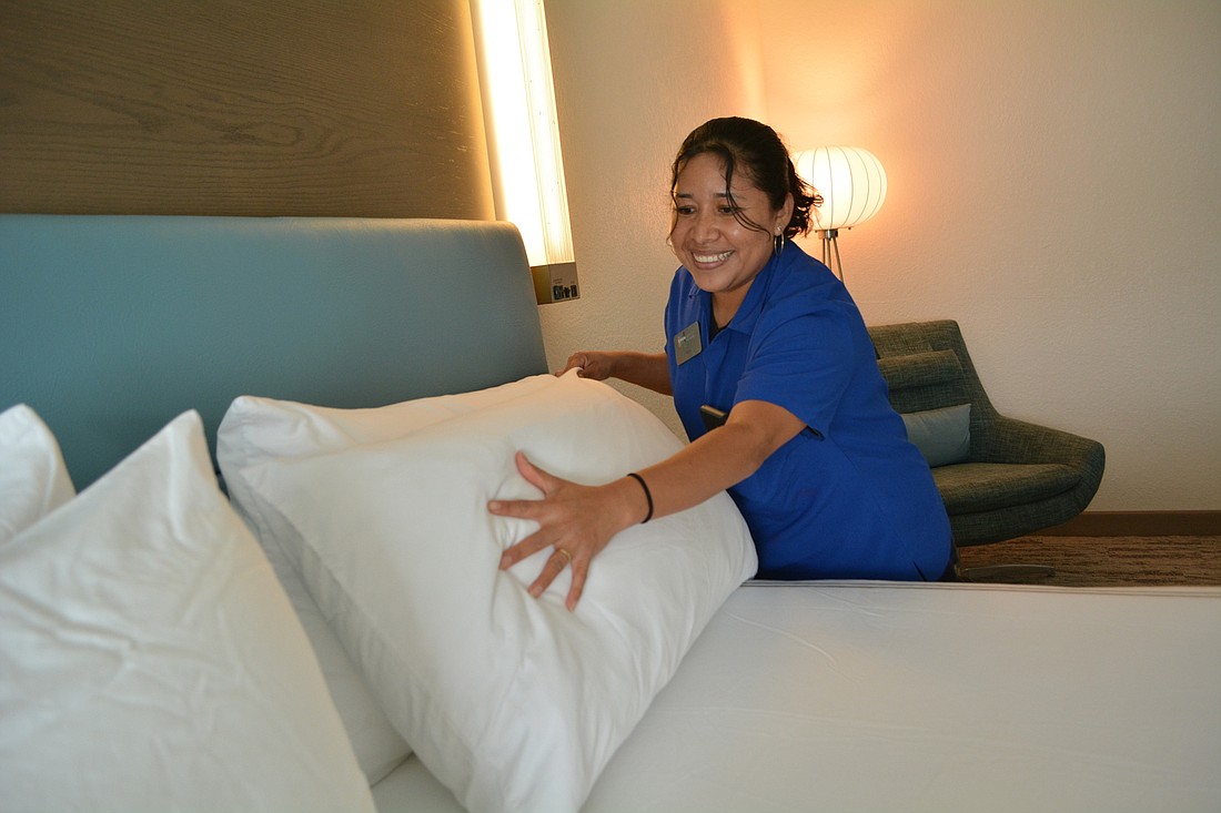 Even Hotels housekeeper  Vicki Jimenez prepares a room for the next guest.