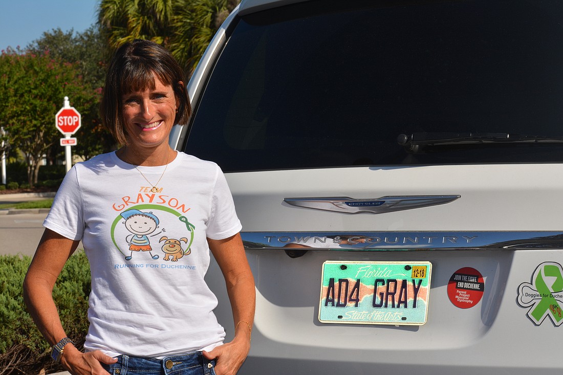 Jennifer Tullio poses with her custom "AD4 Gray" (Another Day for Gray) license plate.