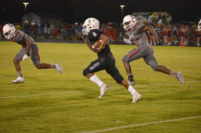 Braden River junior running back Brian Battie flies by the Manatee High defense.