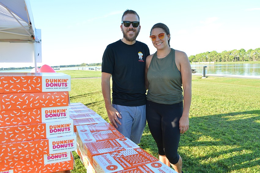 Volunteers Mark and Kaley Jackson prepare to dole out mid-race doughnuts.