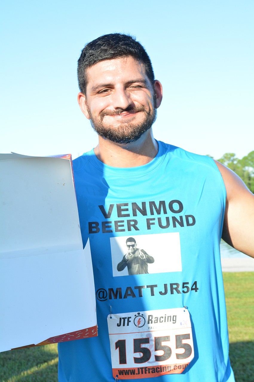 Lakewood Ranch's Matthew Farhat Jr. shows off his empty mid-race doughnut box. After the run, he said the doughnuts gave him a 