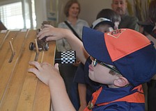 Dexter Trombetta, 6, uses pennies to decorate his car, and says that he wants to work on his car when he gets back home because one of the pennies fell off in the race.
