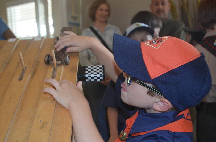 Dexter Trombetta, 6, uses pennies to decorate his car, and says that he wants to work on his car when he gets back home because one of the pennies fell off in the race.