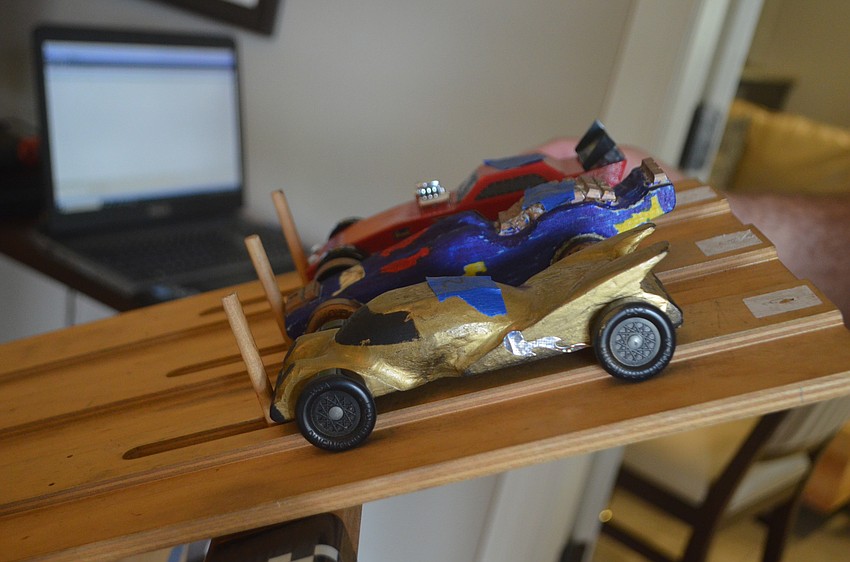 The cars that the cub scouts brought to the race were hand sanded and painted with different designs.