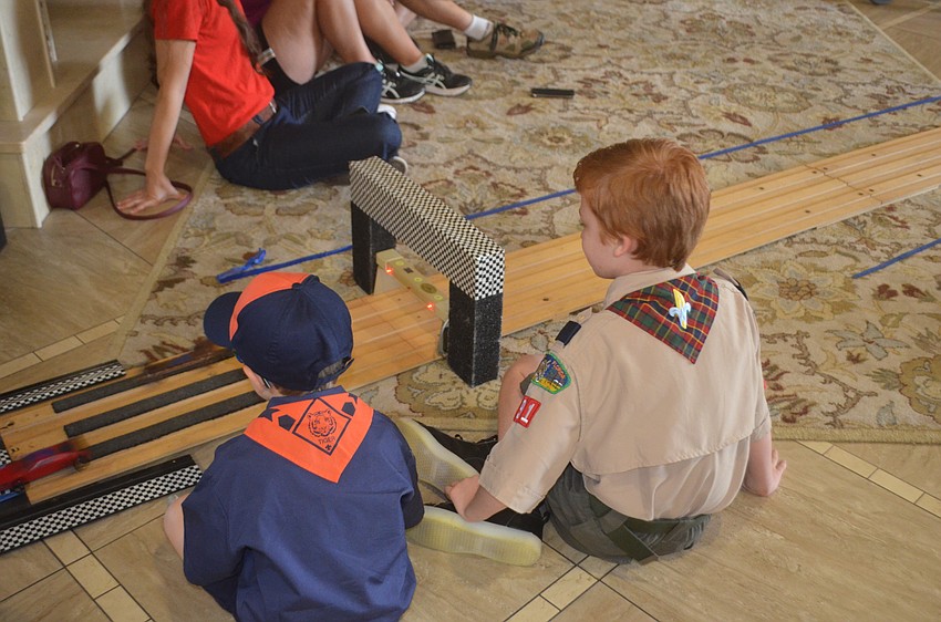 Dexter Trombetta, 6, and Gabriel McFadden, 8, are in charge of bringing the cars back to the start after they finish their race. They say they do it for the senior cars as well, because they can't sit down by the finish line.