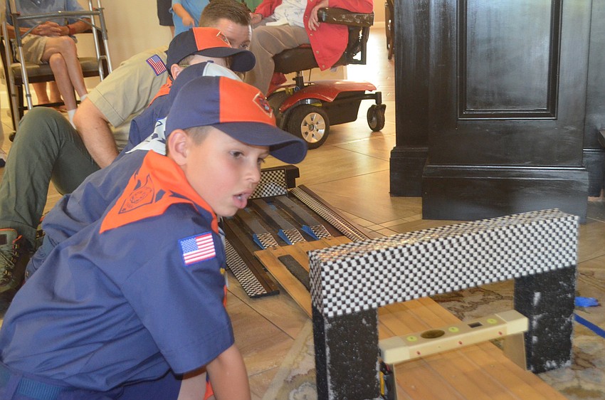 AJ Davis says he likes to watch the cars as they come down the track.