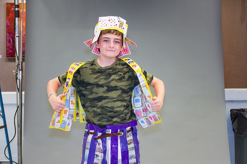 Avery Cole wears an outfit made out of newspaper, playing cards and duct tape. His twin brother, Kennedy, designed the look.