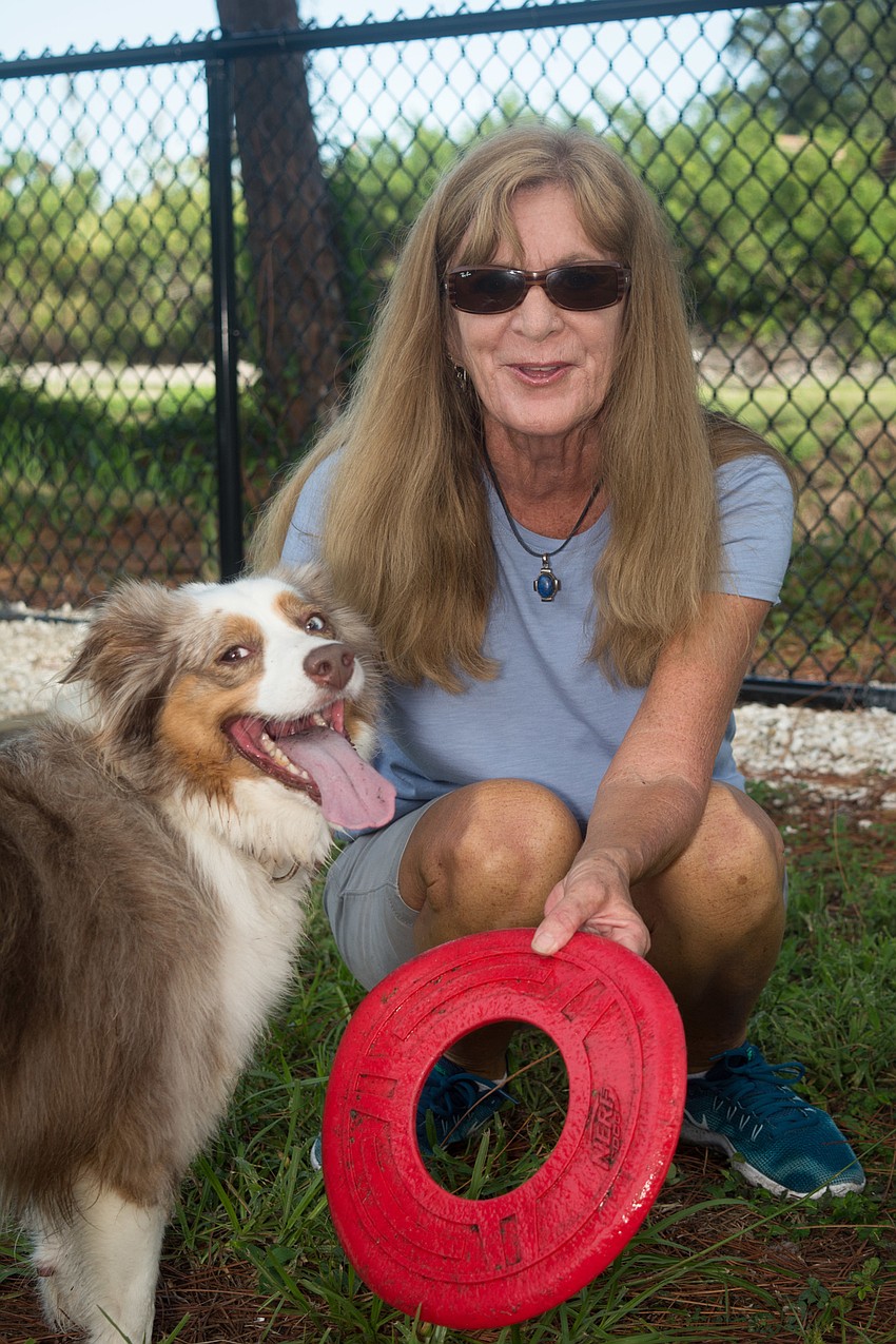 Tricia Whitlock plays with her dog, Willow.