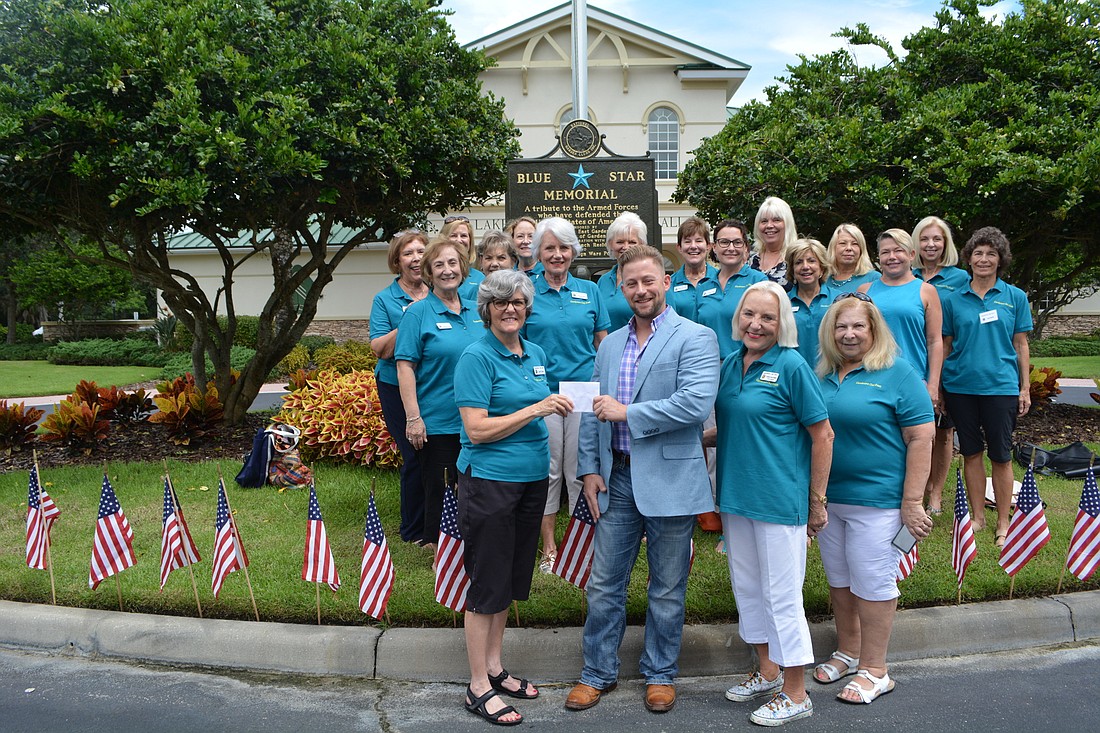 The Gardeners Out East Garden Club in Lakewood Ranch present Vets2Success founder Bryan Jacobs with a check for $2,300 for his Vets to Agro  program.