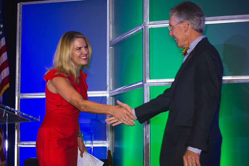Observer Media Group Editor and CEO Matt Walsh accepts the Clyde Nixon Business Leadership Award from Lisa Nixon.