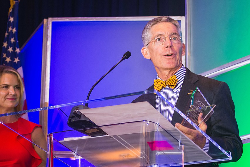 Observer Media Group Editor and CEO Matt Walsh accepts the Clyde Nixon Business Leadership Award