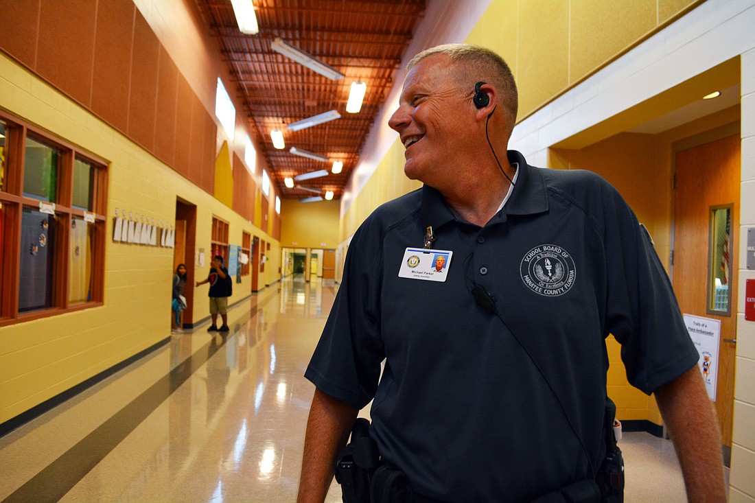 Gilbert W. McNeal Guardian Mike Parker conducts a sweep of the hallways. He says he enjoys talking with kids at lunchtime or visiting the playground. "You can form relationships where they feel like they can talk to you," he said.