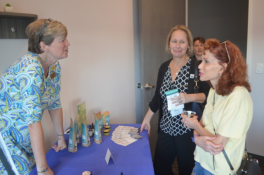 Back to Health Wellness Center's Brenda Green explains the chiropractor business they will offer at the spa to Elena Tadel and Susan Fazzino, who say that the spa is something really special.