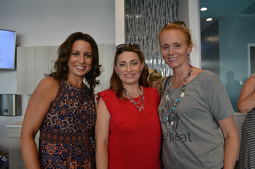 Two Blooms owners Robin Kornett and Melissa Estep meet up with friend Mary Baehr, owner of Big Frog Custom T-Shirts. All three wanted to show support for the new business because they are own small businesses themselves.