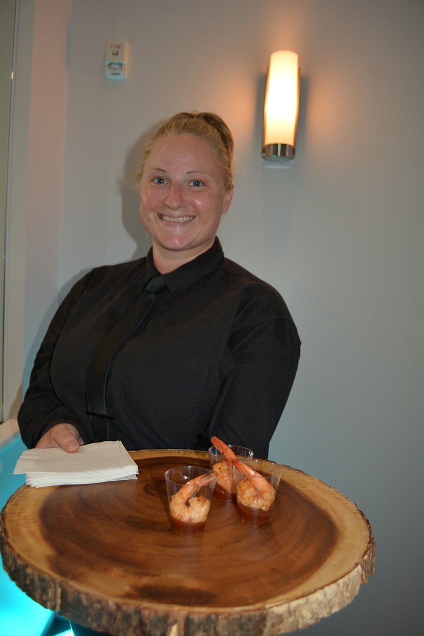 Grace Zastrow serves up shrimp cocktail and other snacks to the crowd.