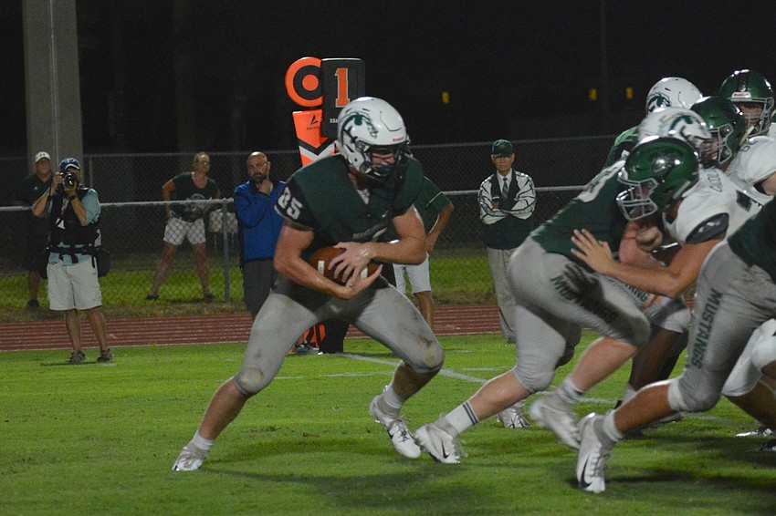 Lakewood Ranch senior Drake Theriot dives into the teeth of the Venice High defense.