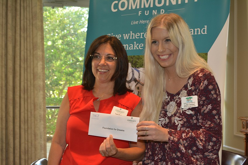 Lori Ruth presents a grant for $5,000 to Lydia Gartner of Foundation for Dreams.
