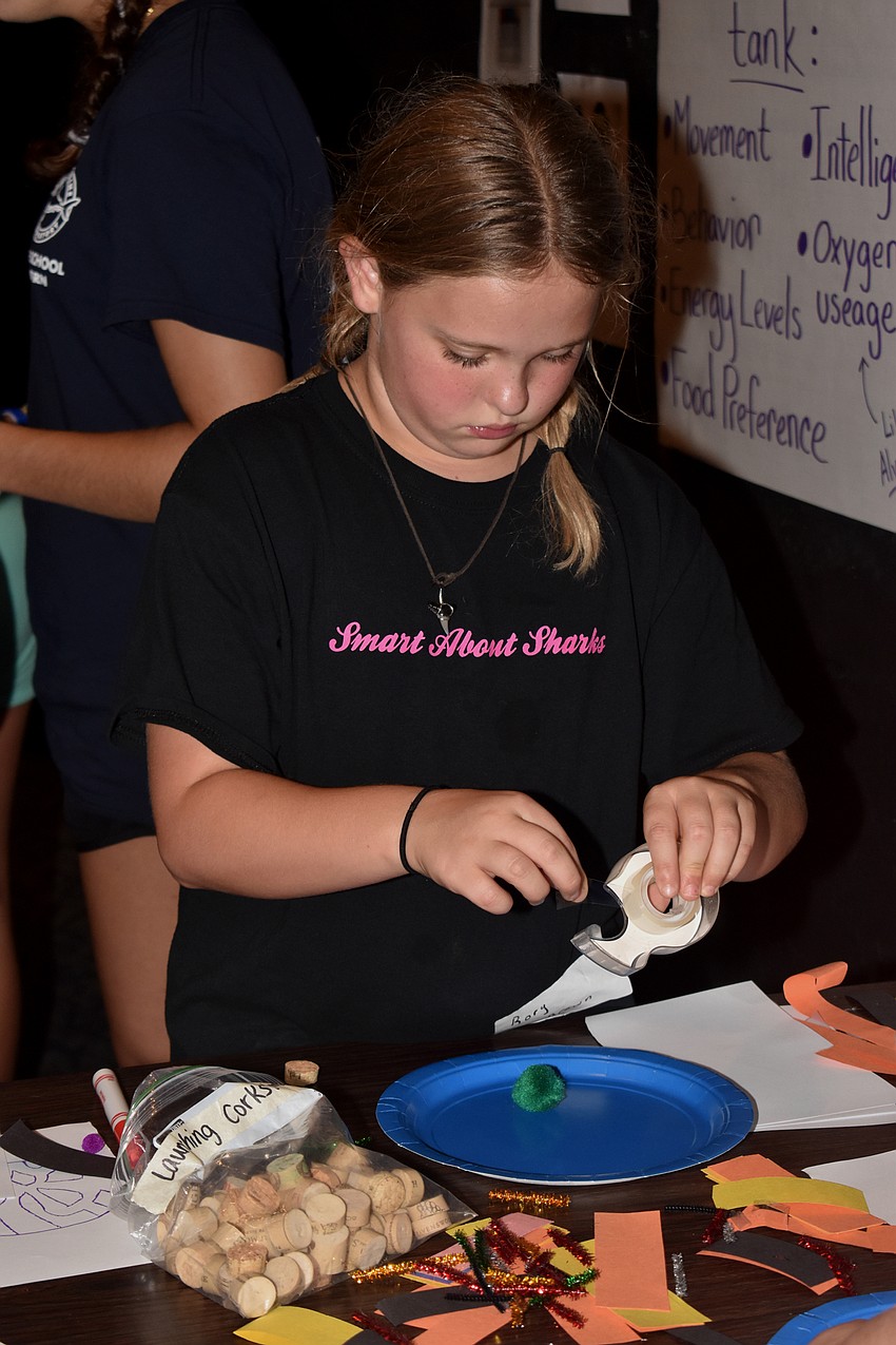 Rory Brown tapes pieces of her shark tank together.