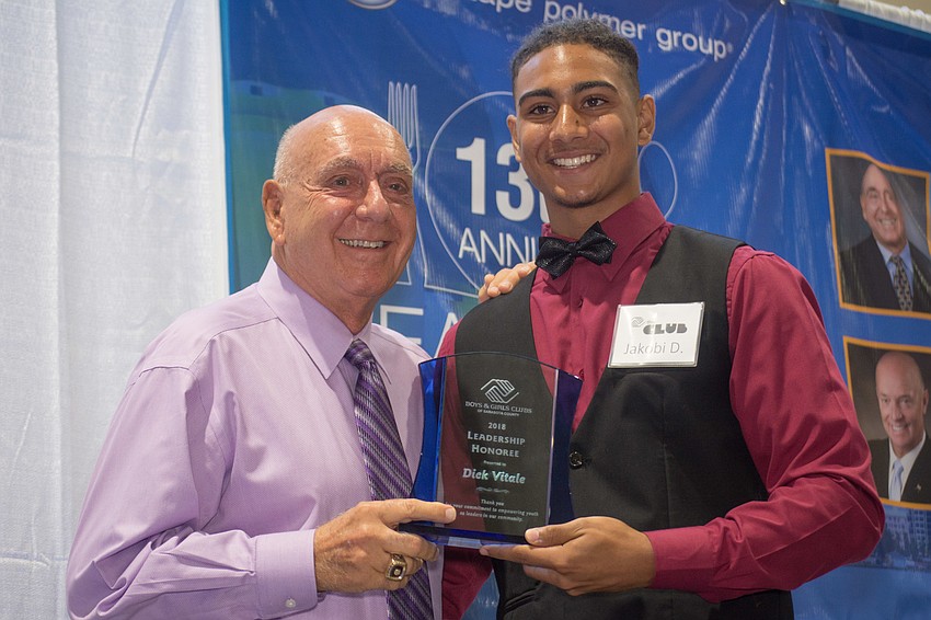 Dick Vitale accepts an award from Boys & Girls Club member Jakobi Davis.