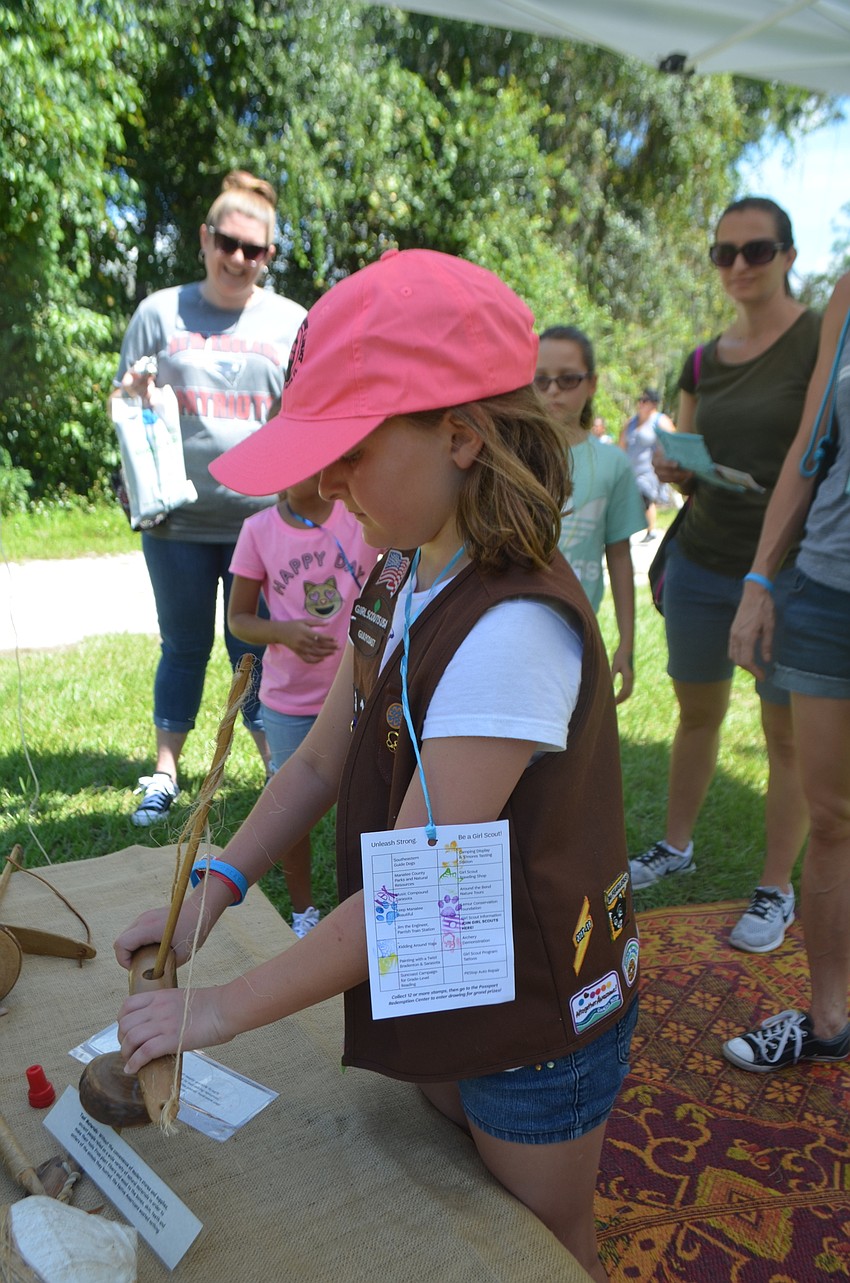 Palmetto 8-year-old Rylee Driggars, from Troop 313, says she enjoyed trying to start a fire with a pump drill.