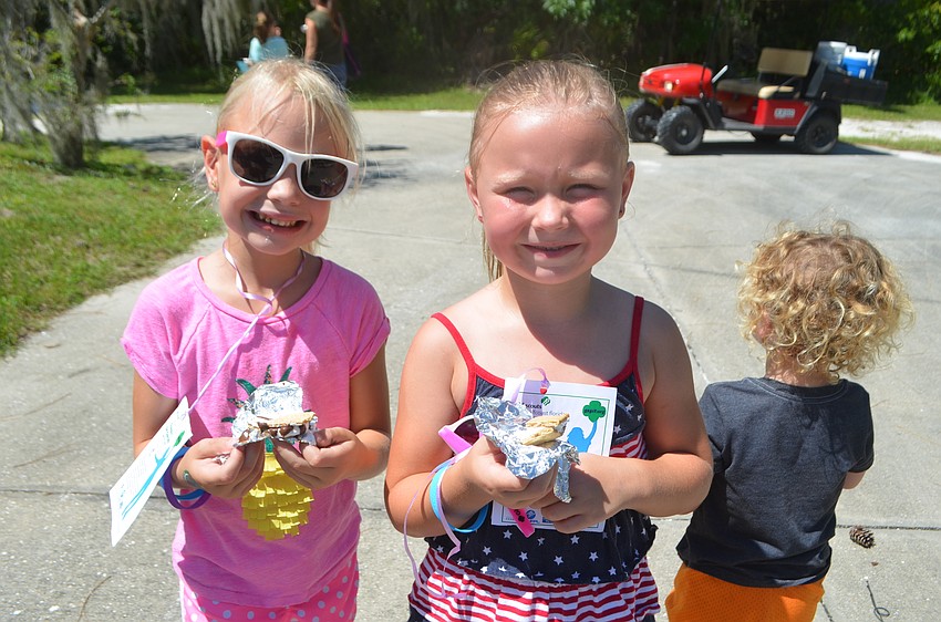 Fort Meyers's Mateel Swearingen, 5, and Emily Page, 6, try their first s'mores.