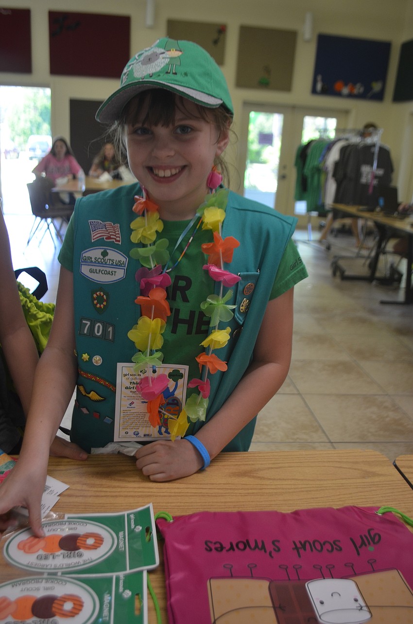 Myakka City's Alice Barr, 9, takes a look at the Girl Scout memorabilia as a way to escape the heat.