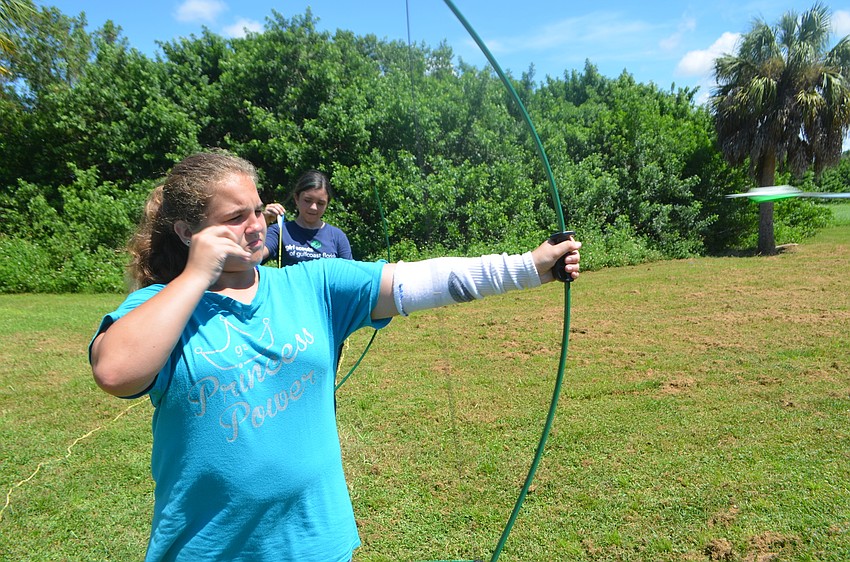 Palmetto's Madelynn Perry, 13, lets an arrow loose at the demonstration. She says that she's inspired by the movie 