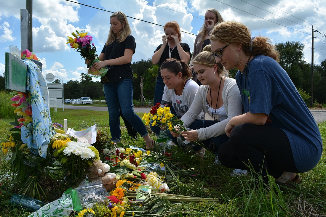 On Sept. 18, Lakewood Ranch High students place flowers at the crash site where a memorial has been erected on State Road 64 and Pope Road.