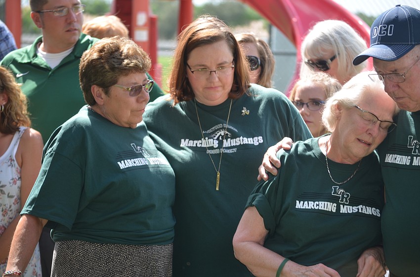 Rebecca Powers comforts Claudia Geist (left) and Mary Powers leans on Ralph Powers for support after Dan Powers gives a quick speech to the crowd of students.