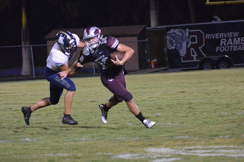 Quarterback Sean White wrestles free from an Alonso defender.