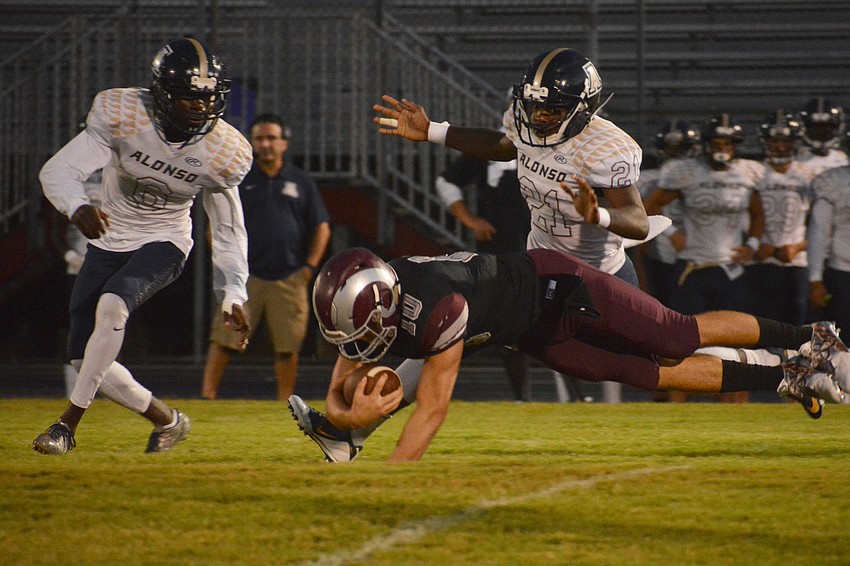 Quarterback Sean White dives for a first down.
