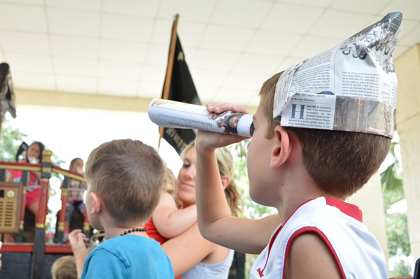 Rylan Enfinger, of Arbor Reserve, gets a closer look at the pirate reading him a story.
