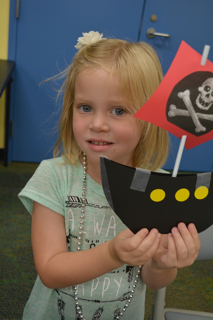 East County's 4-year-old Elise Kapper makes a craft pirate ship from paper, tape, stickers and a drinking straw.