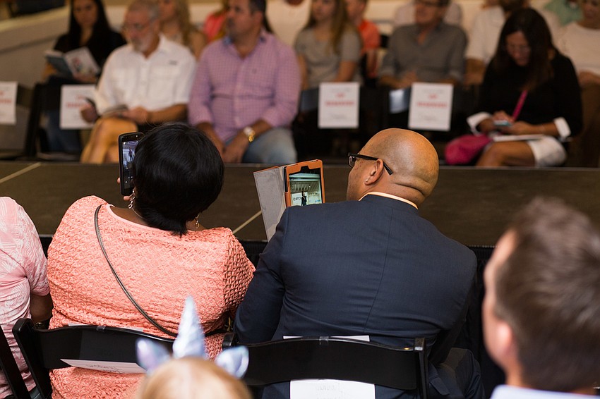 Proud parents watched the show with their cell phones recording video.