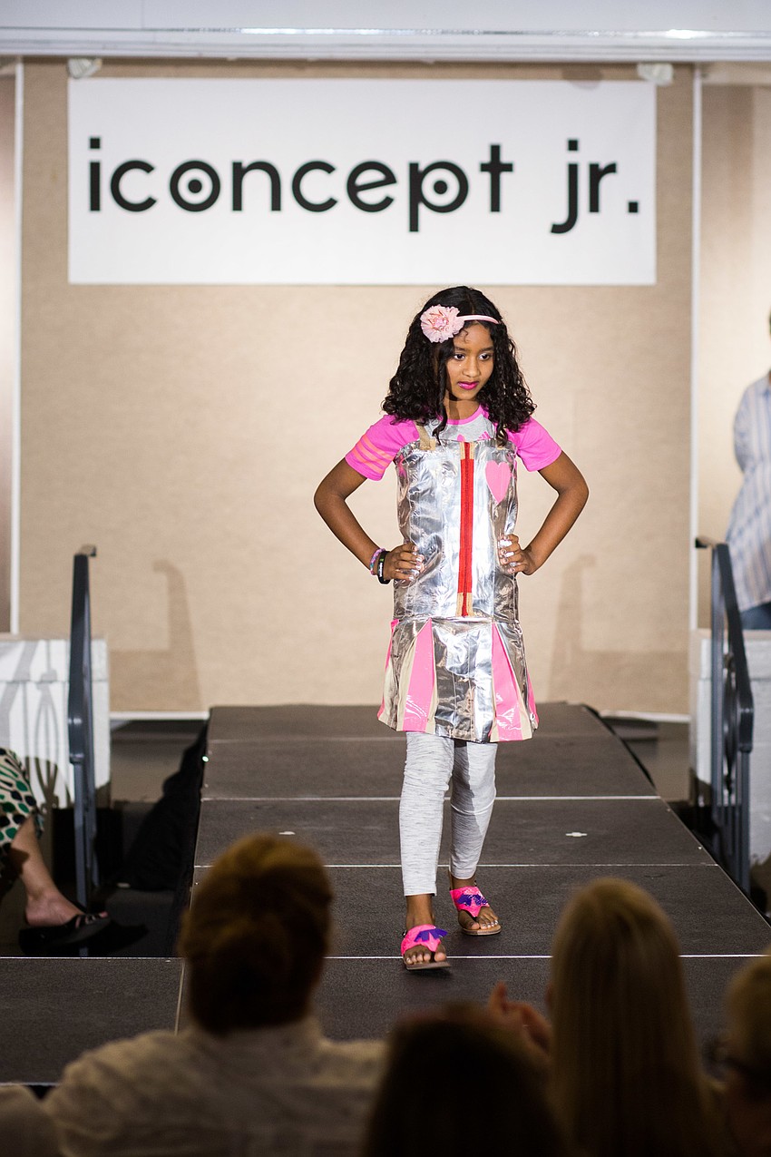 Sarayu Muk Thapuram walks the runway in her design, made with a rice bag, duct tape and old clothes.