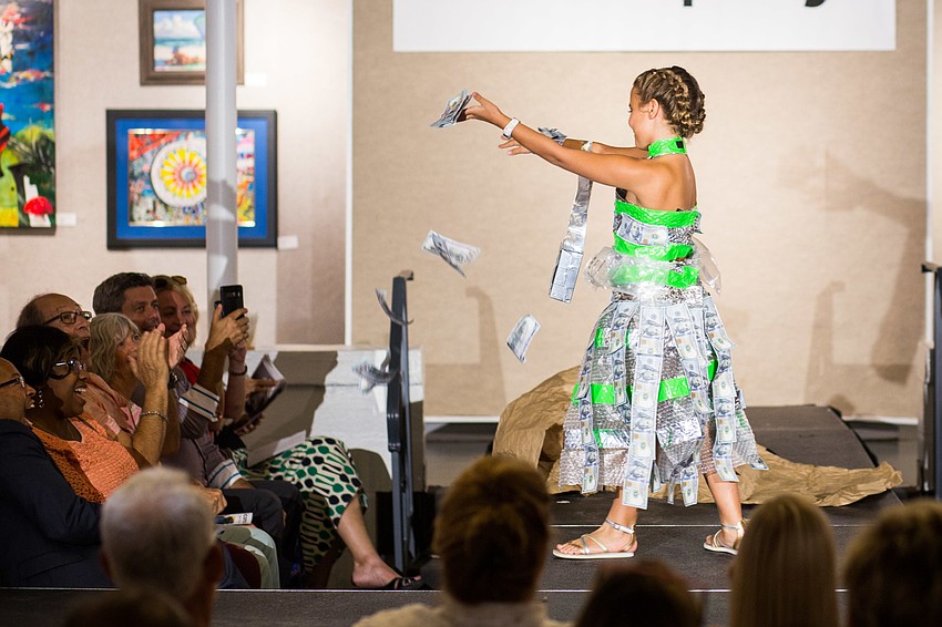 On the runway, Alexandra Misantone threw $100 bills into the audience.