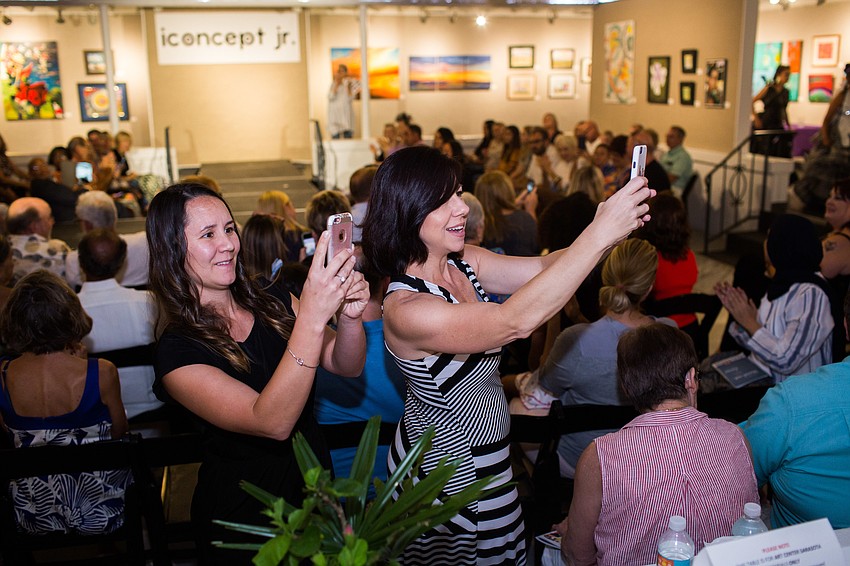 Parents and friends took photos as their young designer walked by.