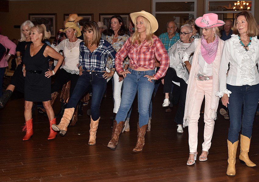 Attendees learn a line dance to “Save A Horse (Ride A Cowboy).”