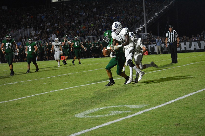 Senior defensive back Mark Davis (2) breaks up a Hayden Wolff pass.