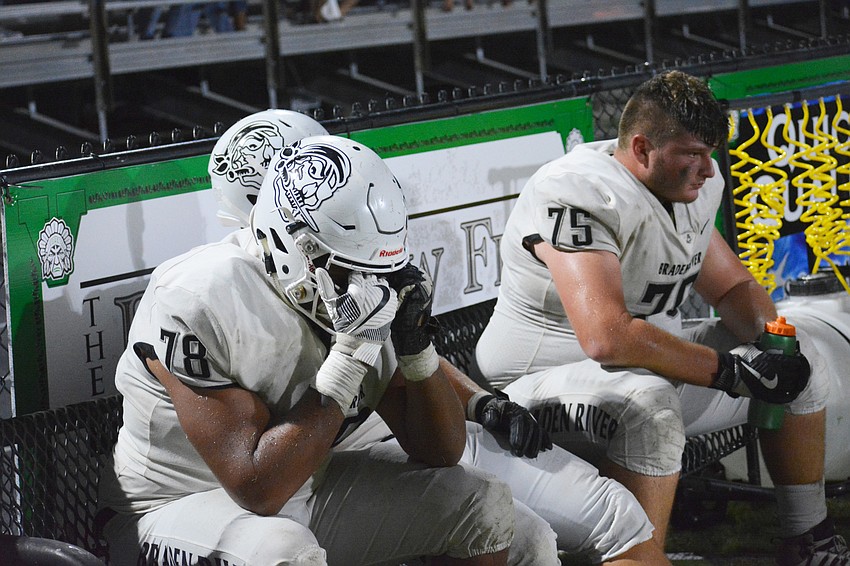Pirates senior linemen Daniel Galvin (78) and Zach Moore (75) process the game's outcome as time expires. The Pirates lost 24-21.