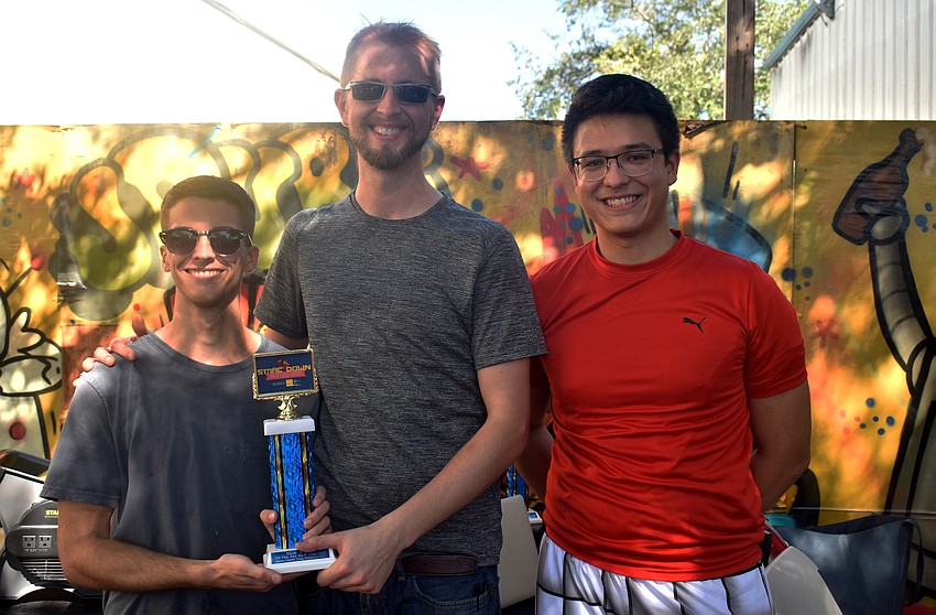 Ryan Duffey and Jess Zellner of Melange, which won Best Exotic Dish, with Sarasota Young Professionals Group Chairman Rob Young