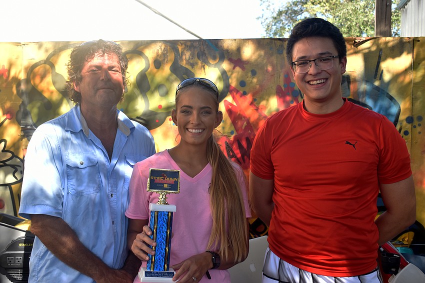 Mark Ibasfalean and Destiny Ibasfalean of the Seafood Shack, which won Fan Favorite, with Sarasota Young Professionals Group Chairman Rob Young