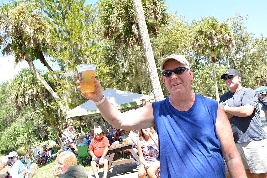 East County's Frank Colgan raises his beer for the musicians. He bicycled to Linger Lodge for the festival.