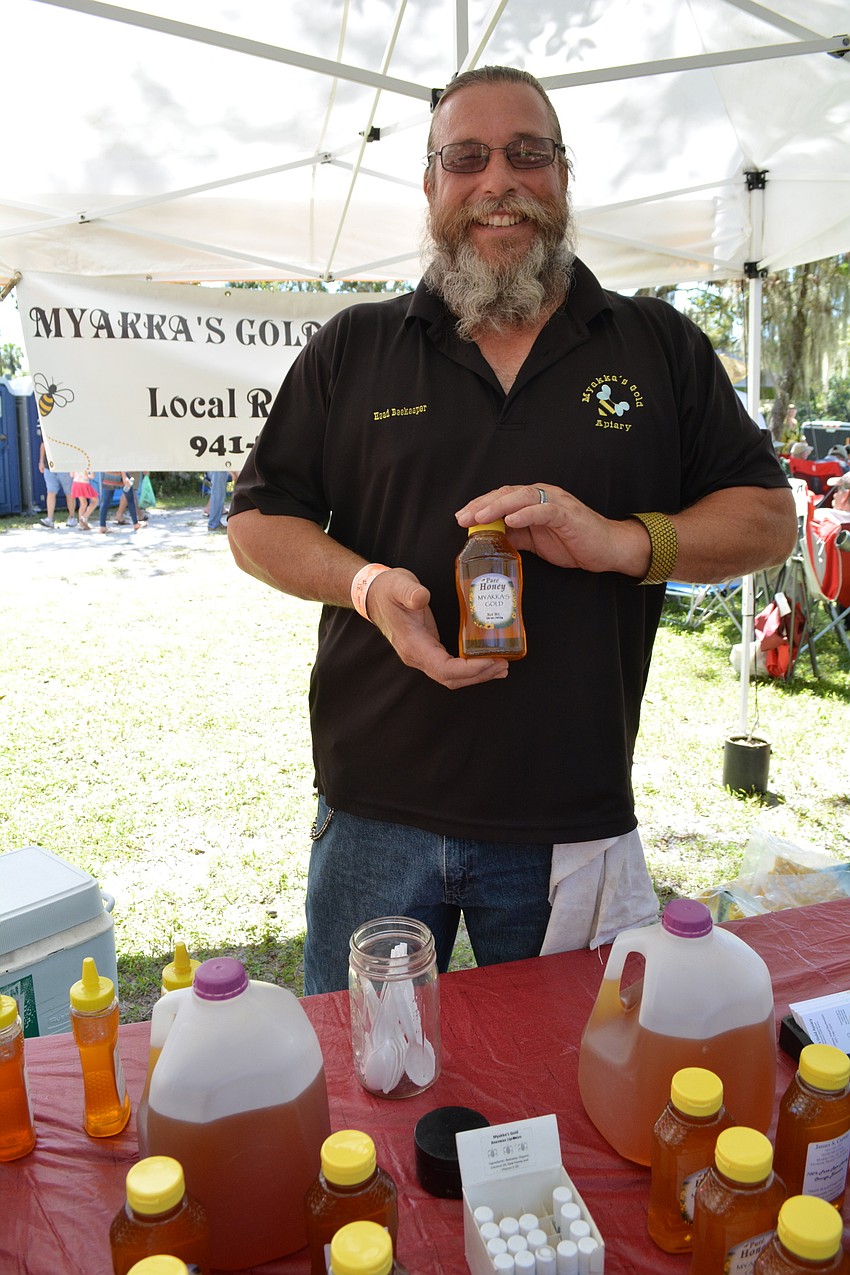 Myakka's Gold Apiary beekeeper Jim Cutway sells his honey at the festival.
