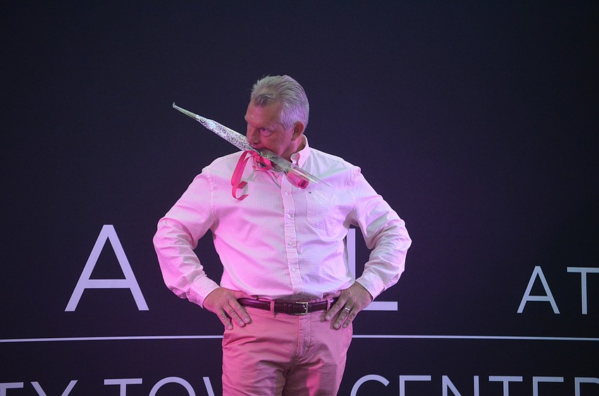 Sprint Wireless's director of sales Dan West tries to get the most votes to win the fashion show's most liked model award.