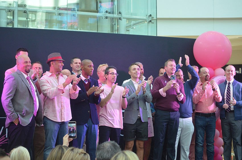 All of the men walking in the fashion show were all touched by breast cancer in some way.