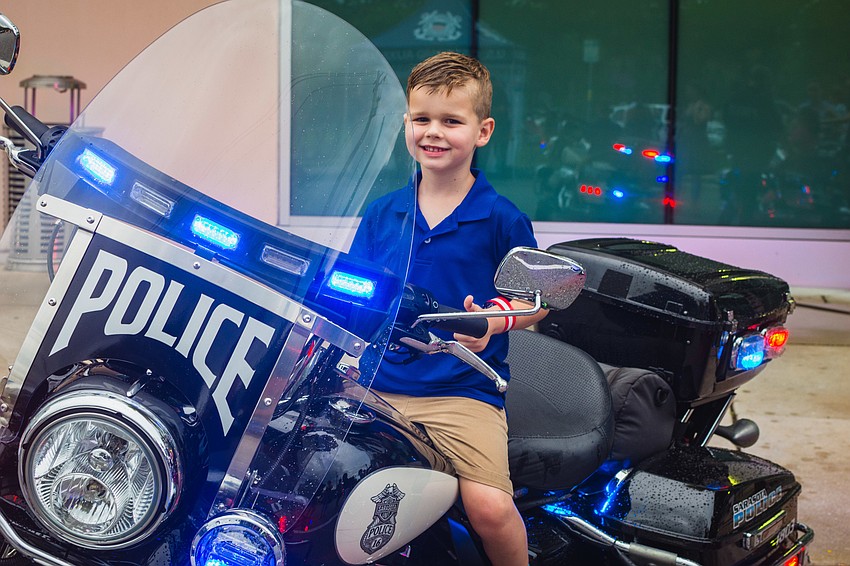 Ben Bernard tests out a police motorcycle.